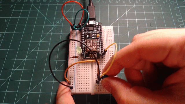 An LED connected to GPIO5 and a potentiometer connected to ADC0.
